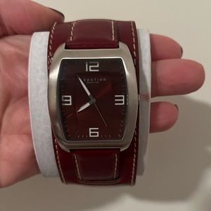 Kenneth Cole Reaction watch. Red leather strap. Cream stitching. Made in China.